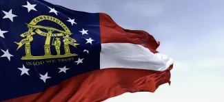 Image of the State of Georgia flag stretched out by a breeze.