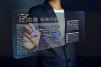 Individual in a blue suite accessing a digital timeline of a project